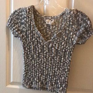 grey and white shirt with v neck cut